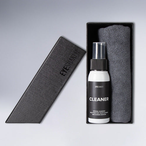 Eyewear Cleaning Kit standing on a desk, including a cleaning spray for glasses and a microfiber cleaning cloth